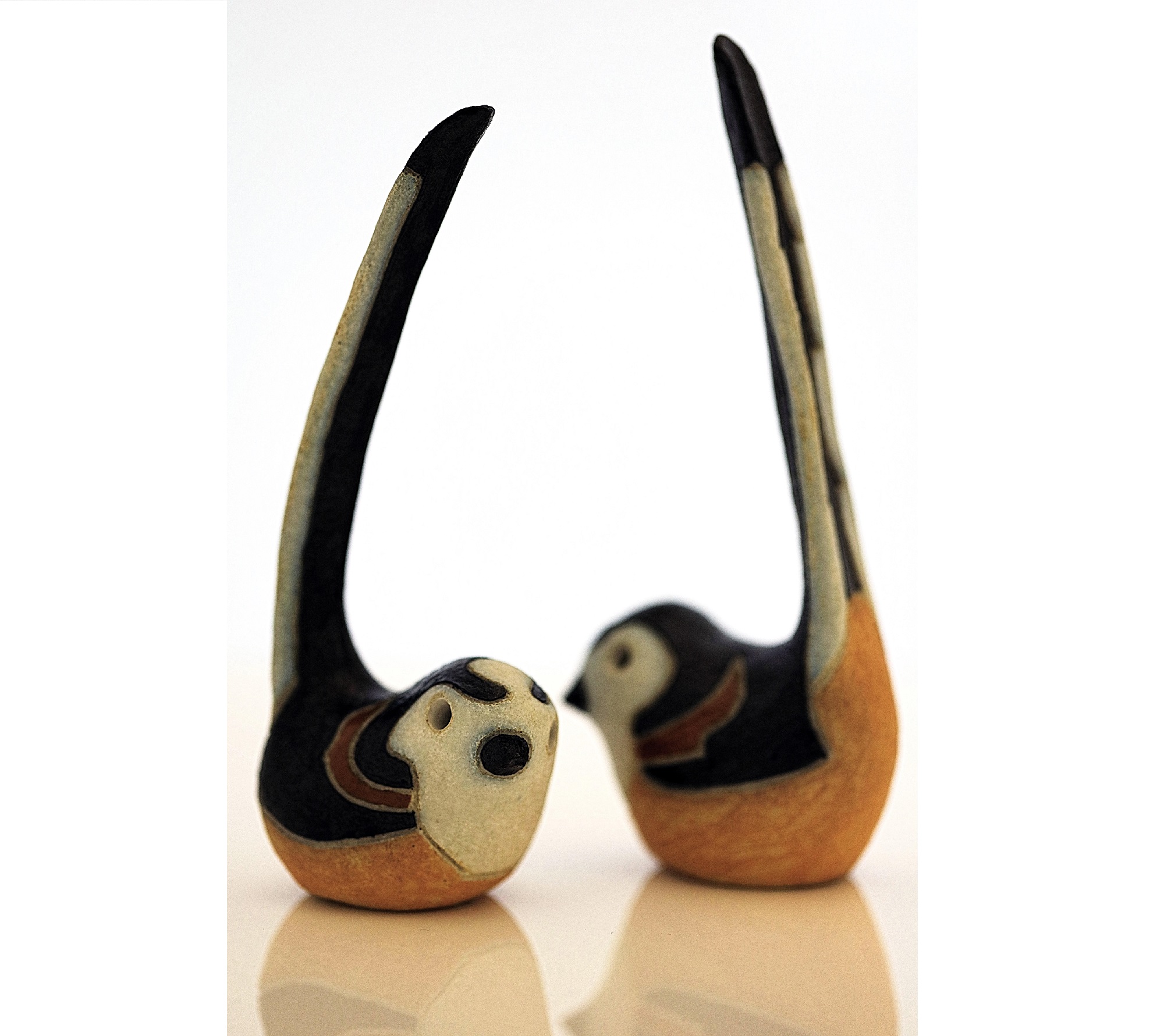 Long-tailed tits, just over life-size, with a black and white matt glaze. These were one of three pottery birds created in 1987 by Rosemary Wren and Peter Crotty from drawings from life.