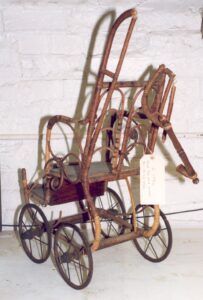 A Victorian doll's push chair, c. late 1800s.