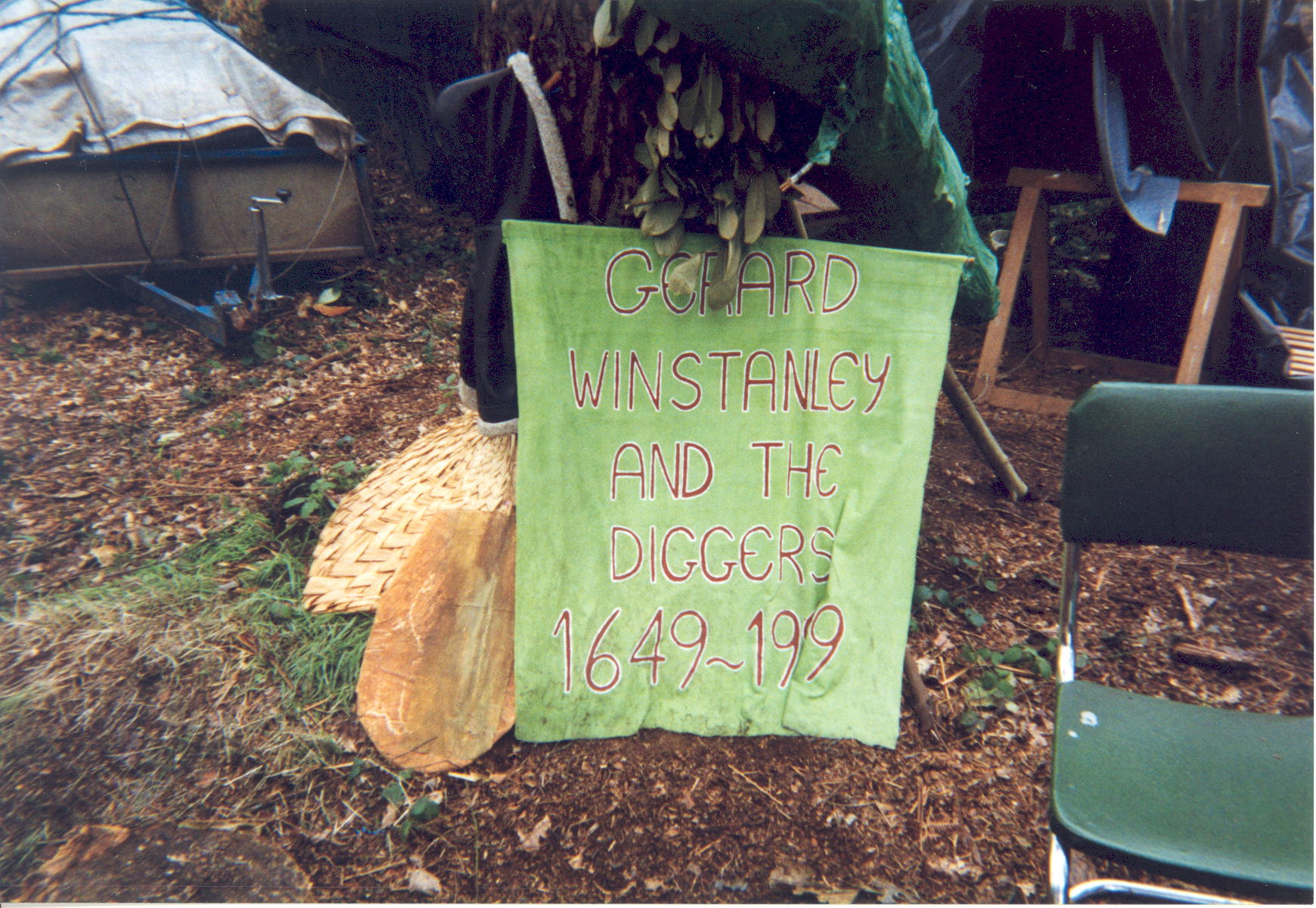 Photograph showing a green cloth banner inscribed in red: 