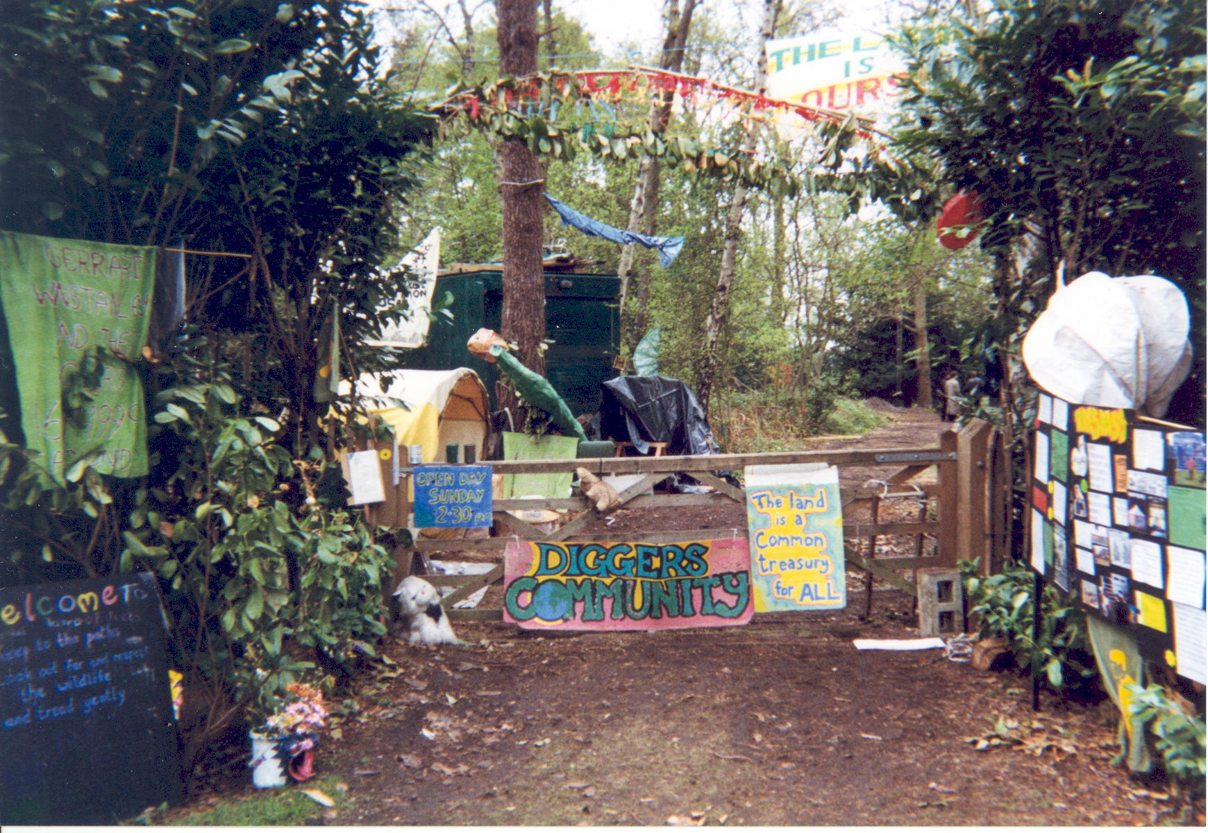 The entrance to the Land is Ours camp, April 1999. A gate with two large signs on it inscribed 