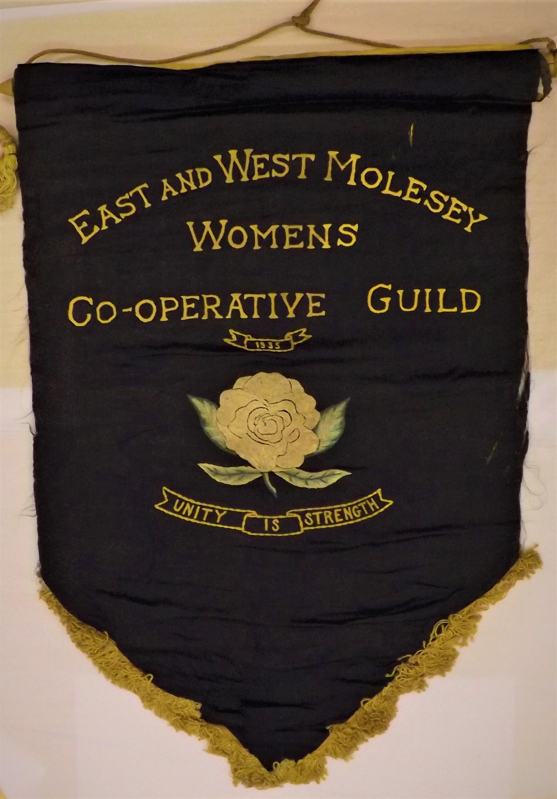 Banner from the East and West Molesey Women's Cooperative Guild, an organisation descended, in part, from the Women's Freedom League.