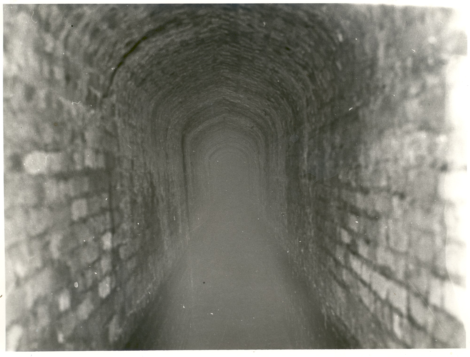1920s black and white photograph of the interior of the Great Culvert which was inserted into the moat of Oatlands Palace.